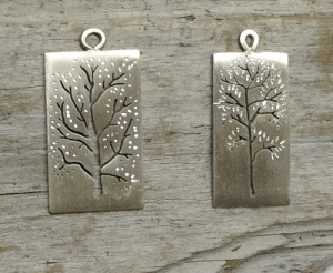     A bigleaf maple (left) and alder cut into sterling silver. Can be worn with the naked winter tree showing or turn it over and celebrate spring with a crown of leaves. The alder pendant is 10mm wide. Each pendant comes on an 18" sterling silver chain. $45 and $42