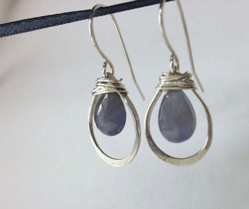     Soft blue coloured sapphires in ~18mm long drop shaped hoops. Sterling silver. $60 Rough cut blue sapphires on 25mm silver stems. All silver is sterling. #35